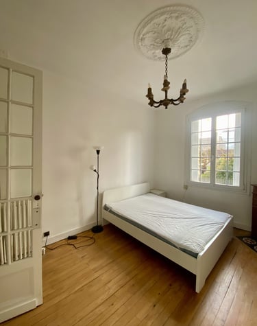 a bed in a room with a chandelier and a chandelier