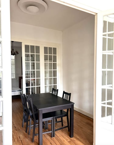 a dining room table with chairs and a table