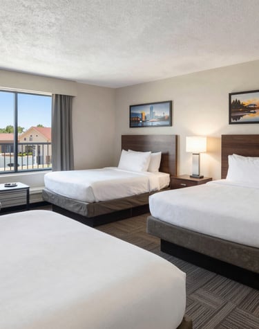 Cozy hotel lobby with comfy seating areas and warm lighting perfect for team gatherings.