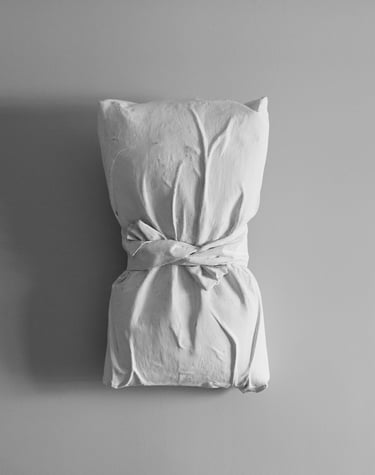 A pillow that is wrapped in plastered fabric