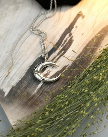 14kt white gold crescent moon pendant with flush set white sapphire