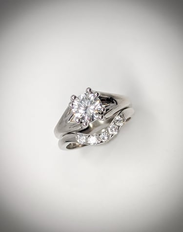 White gold solitaire diamond engagement ring complimented with a matching wedding band. 