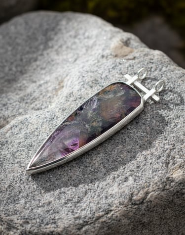Hand Cut Super 7 cabochon set in sterling silver pendant by Kelly Allanson