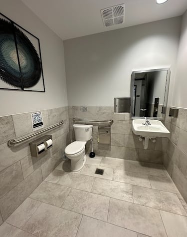 <img src="bathroom-remodel.jpg" alt="Modern commercial bathroom renovation with new tile flooring and fixtures by Retail Work