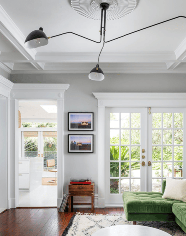 a living room with a green couch and a green couch