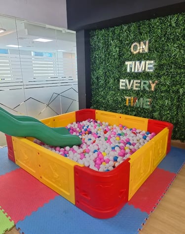 a play area with a slider and a slider in the middle of a