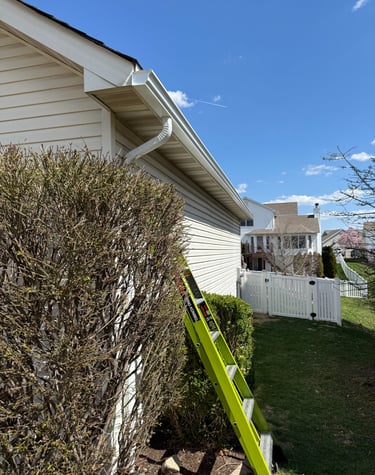 fiberglass ladder used to reach downspout