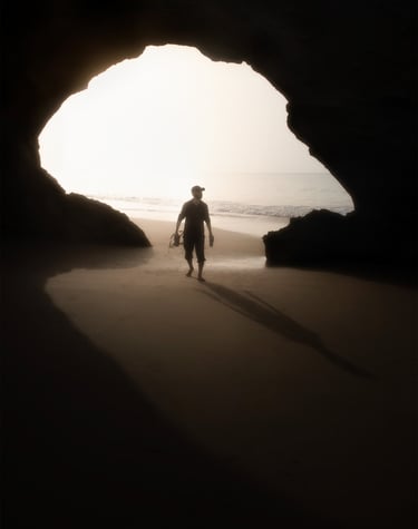 a man walking on the beach with a surfboard . arbab naimat kasi balochistan