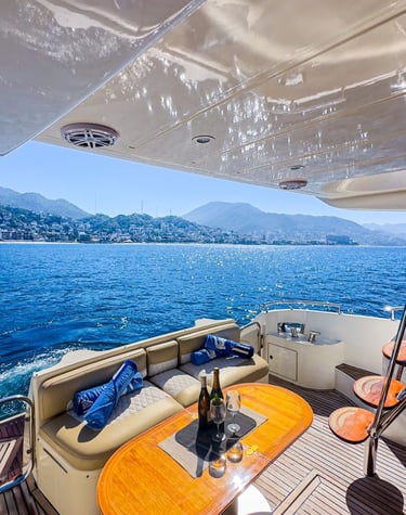 a boat with a table and chairs on the deck