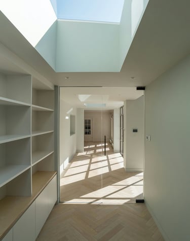 a room with a skylight and a wooden floor