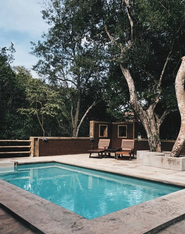 a pool with a tree in the background ingenieria ferram