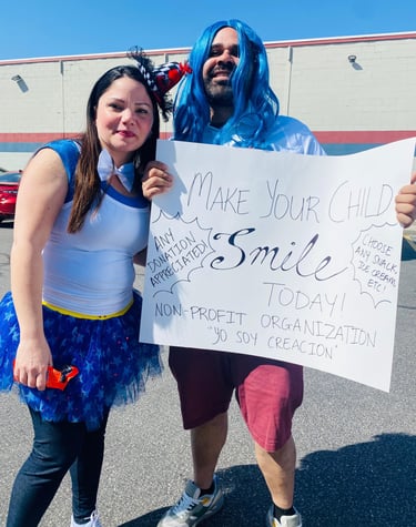 Volunteers in costumes hold a non-profit donation sign for Yo Soy Creacion outside a building.