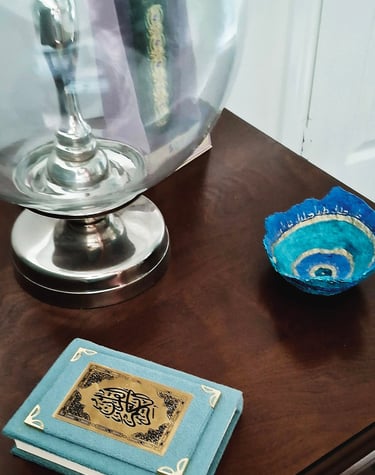 solid wood table with glass and metal lamp base and teal accessories