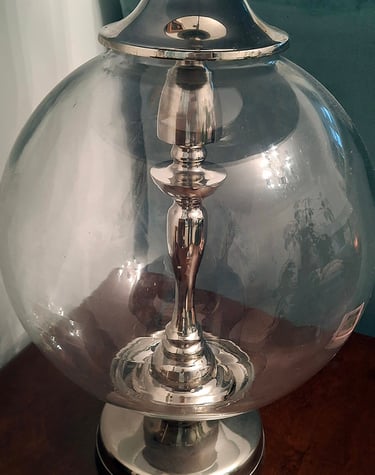 large glass and metal lamp base with a turquoise silk lamp shade