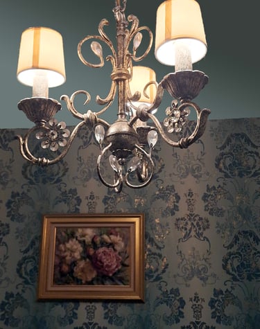 soft teal gilded wallpaper, oil painting and silver chandelier