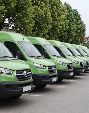 An outdoor shot of commercial cleaning vehicles lined up, ready for deployment.