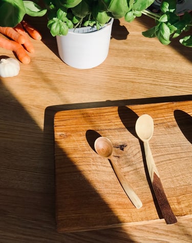 a wooden spoon and spoons on a table