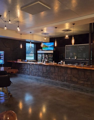 Brickyard Events bar featuring warm brick accents and a natural wood bar top, styled for wedding and