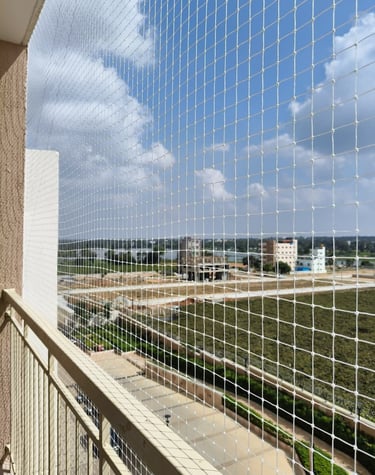Wide-angle view showing a balcony fully protected by Arjilli Safety Nets.