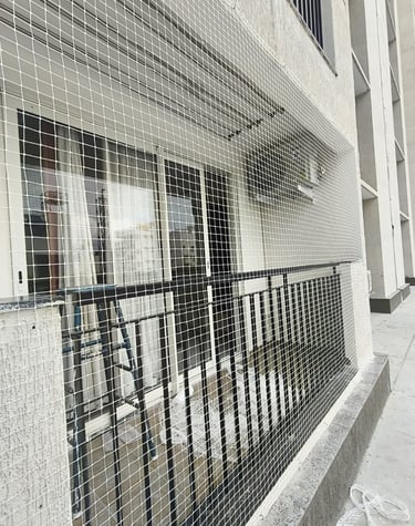 Daytime view of a terrace fenced with durable pigeon nets, keeping the area safe and bird-free.