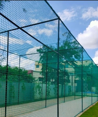 Wide-angle view showing a rooftop sports net installation overlooking the Mumbai skyline.