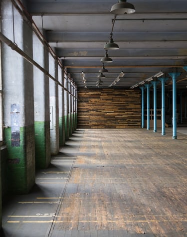 Main room image showing the wooden floor and revered Pallet Wall