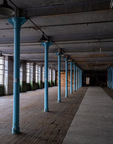 Image of the main room showing the wooden floor, Pillars, large windows and Palletwall.