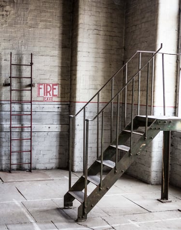 Original fire exit and metal loading stairs along with the Stone floor and 6 metre high original windows at Atlas Studios
