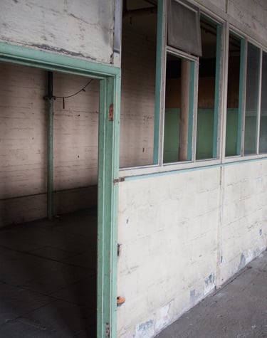 Original Overseers office in the Stone room, with peeling paint and industrial feel in the Stone room at Atlas Studios.