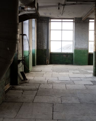 Original industrial pipework and gears in the Stone Room at Atlas Studios