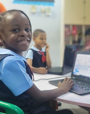 A kindergarten 2 pupil using the computer in a classroom