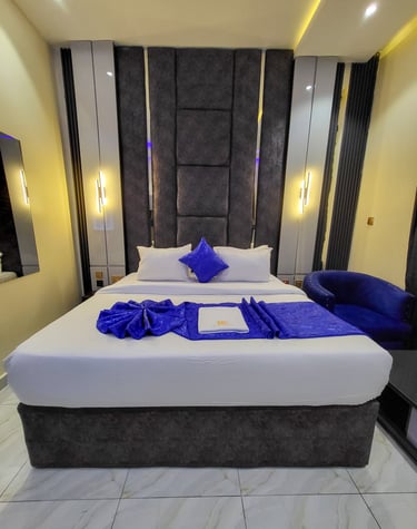 Cozy guest room featuring plush bedding and sleek interior design.