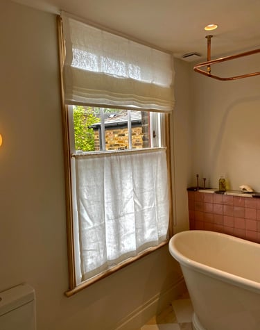 chorki bathroom with a roman blind and cafe voile curtains