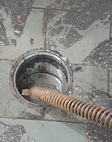 a drain hole in a drain with a metal pipe