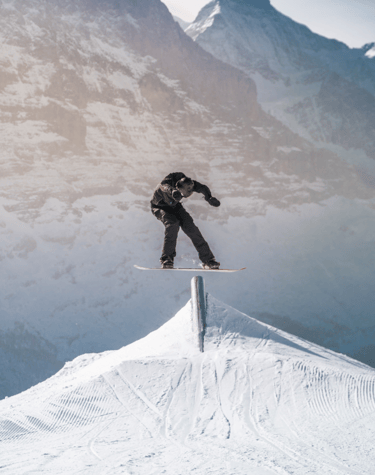 a snowboarder is doing a trick on a snowboard