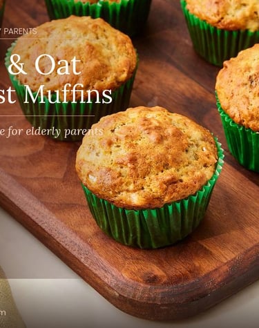 Freshly baked banana and oat breakfast muffins in green liners on a wooden board.