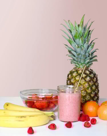 a pineapple and fruit smoothie with raspberries and strawberries