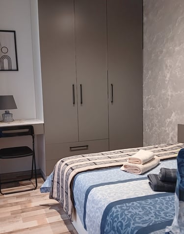 alt="Bijoux Apartment bedroom with cozy bed and modern decor"