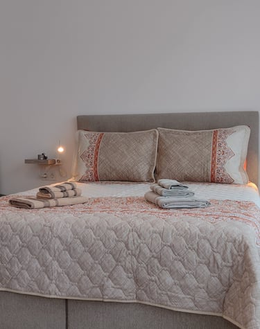 alt="Harmony Apartment bedroom with cozy bed and modern decor"