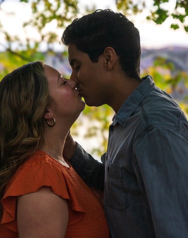 Two people kissing in a romantic setting