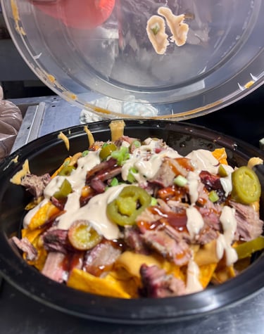 Not Cho Mama’s Nachos loaded with brisket, cheese, jalapeños, and BBQ drizzle from Marion Ohio 