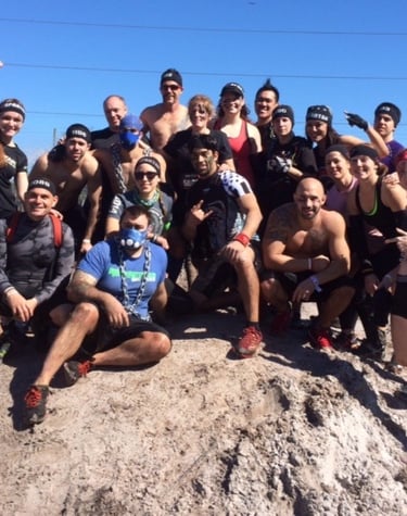 a group of people standing on top of a rock