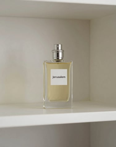 A luxurious perfume bottle with a metallic cap and amber-colored liquid, featuring an ornate and stylish label displaying intricate designs. It is placed on a dark, reflective surface.