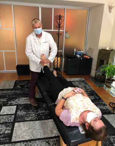 Dr. Lonna Denny performing a leg adjustment to her female patient.