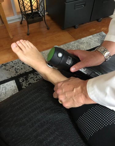 Dr. Lonna Denny peforming a cold laser therapy to her patient's ;eg/