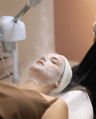 a woman getting a facial mask with a facial mask