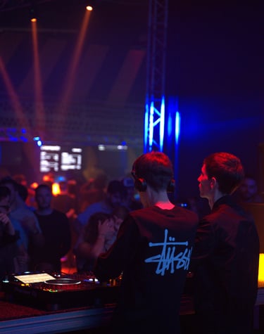 a dj spinning around in a nightclub