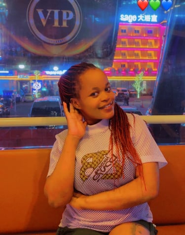 Experienced home massage therapist in Pattaya with a friendly and welcoming appearance, photographed in a night market