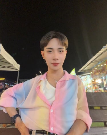 Experienced home massage therapist in Pattaya with a friendly and welcoming appearance, photographed in a night market