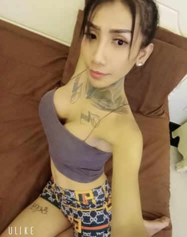 Ladyboy Pattaya home massage therapist sat on a sofa